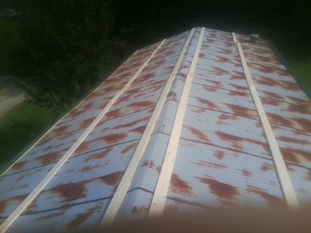 Rusted metal roof panels with new wood purlins before replacement — Storm Damage Roof Repair in Zionsville by Roofing Brothers